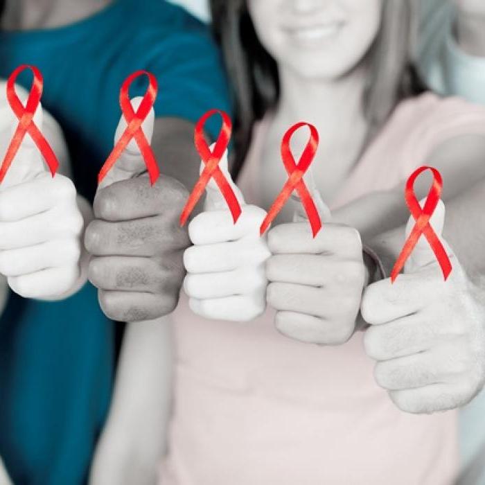 several people with red ribbons on their thumbs